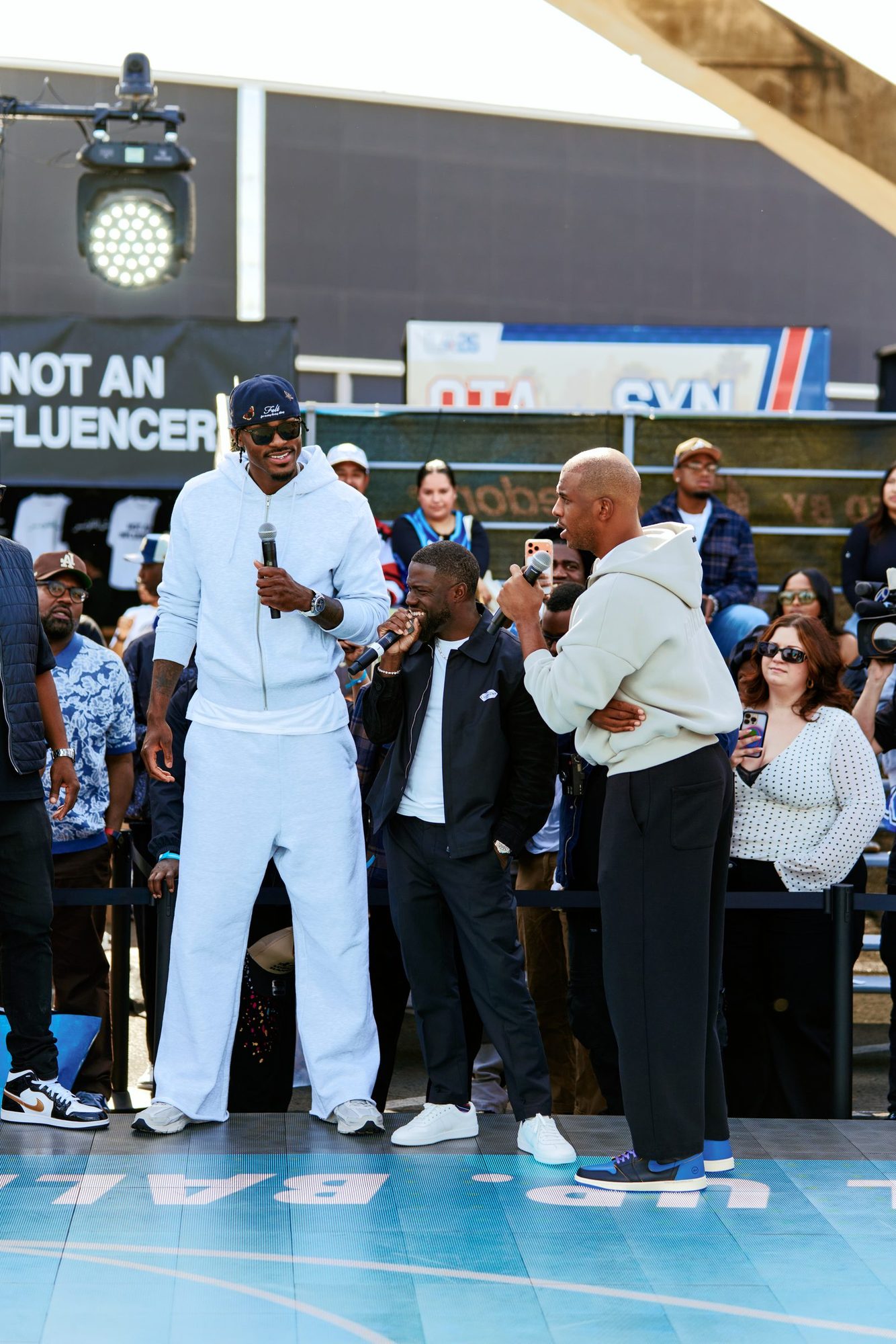 Hosts with microphones on the outdoor court stage