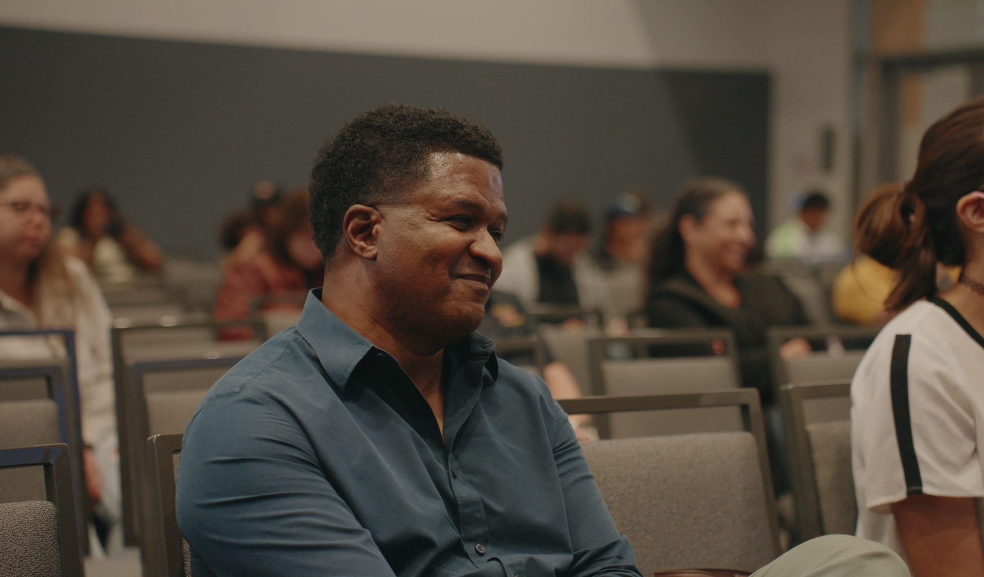 Attendee smiling in the audience