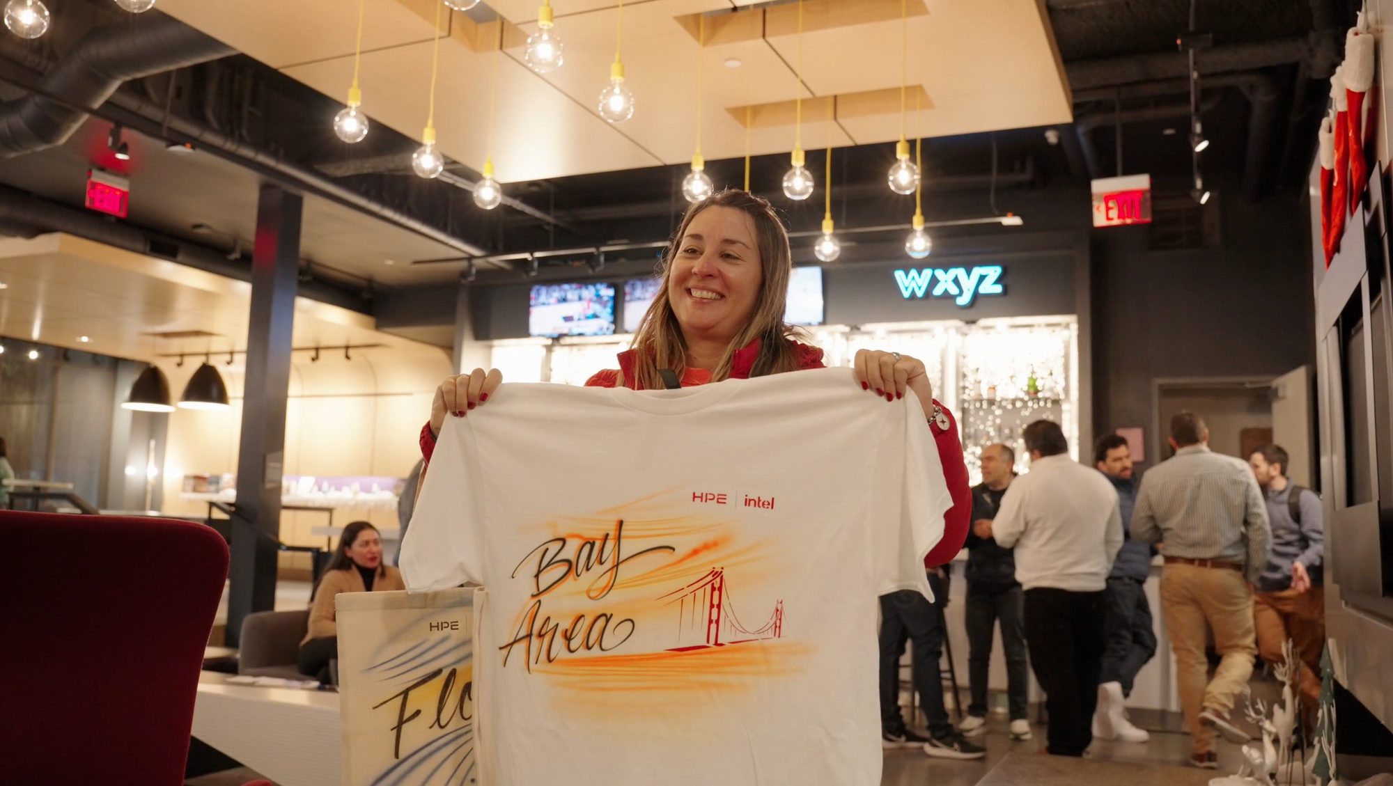Guest holding up a custom airbrushed Bay Area shirt