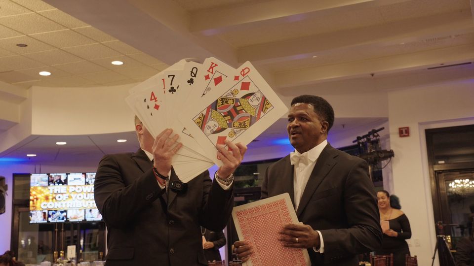 Guests holding up oversized playing cards