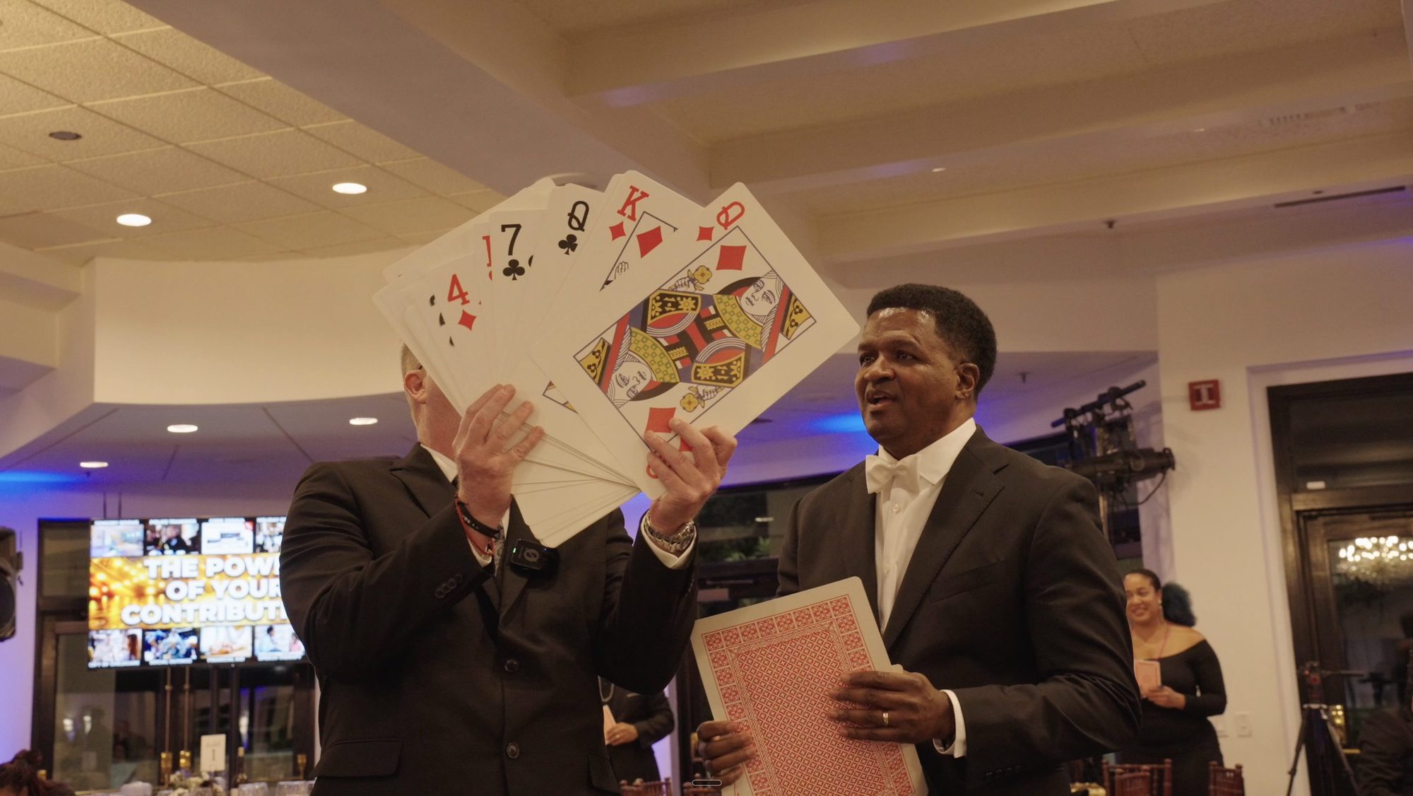 Guests holding up oversized playing cards